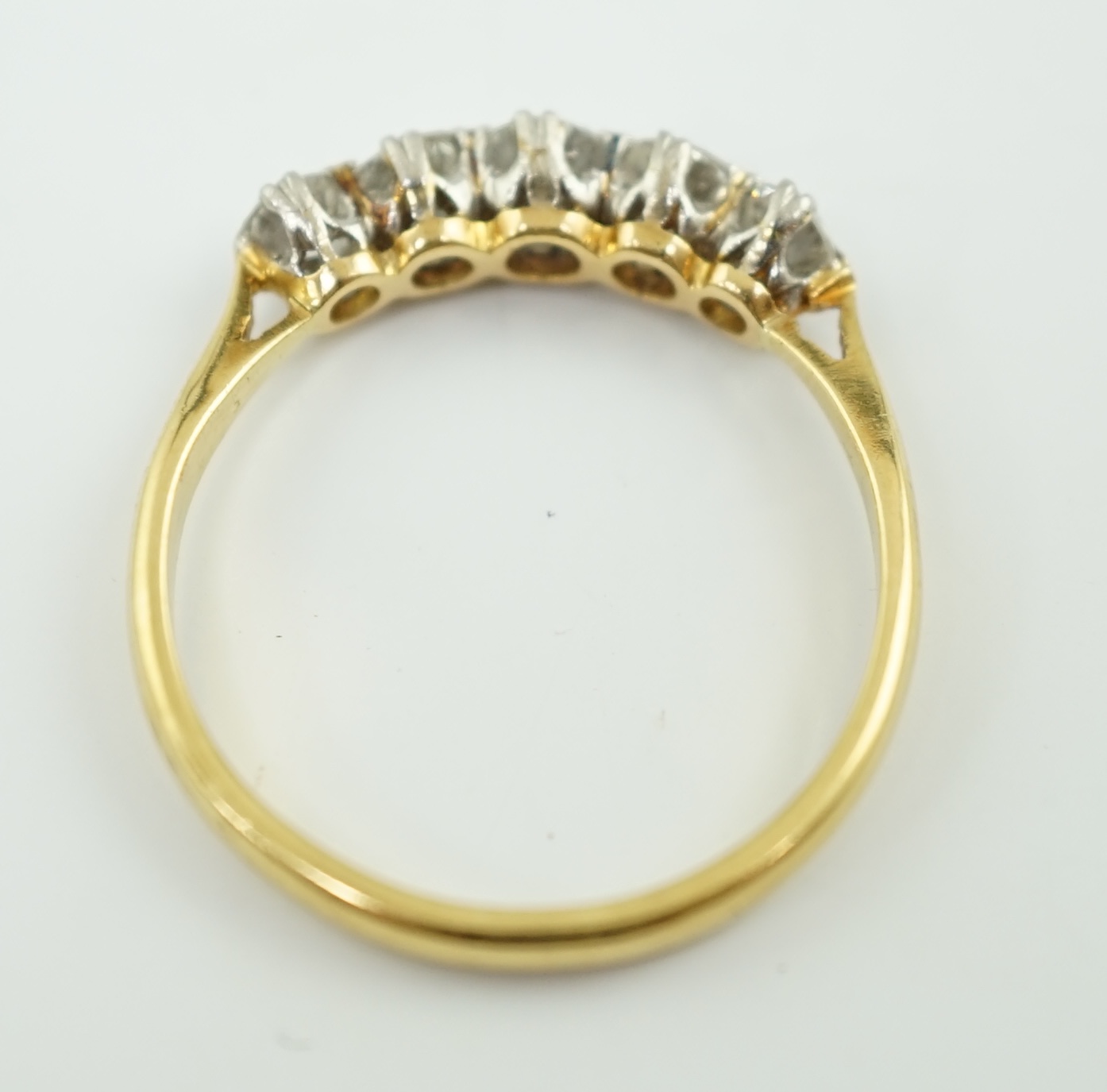 An 18ct gold and graduated five stone diamond set half hoop ring